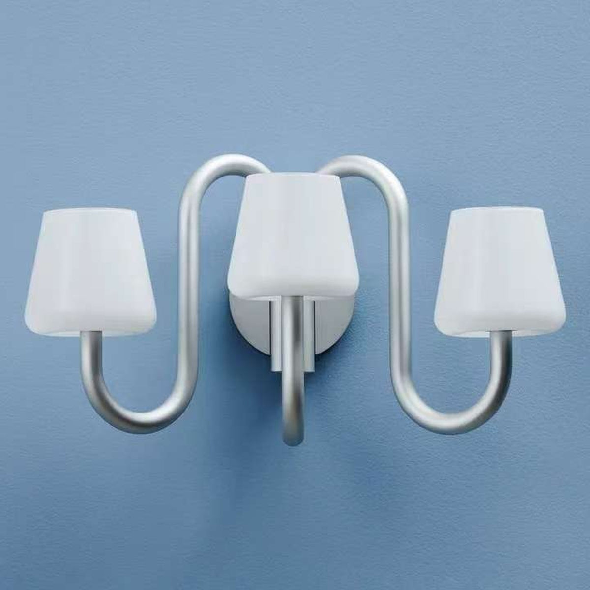 Front detail of the Apollo three-light wall sconce on a blue wall