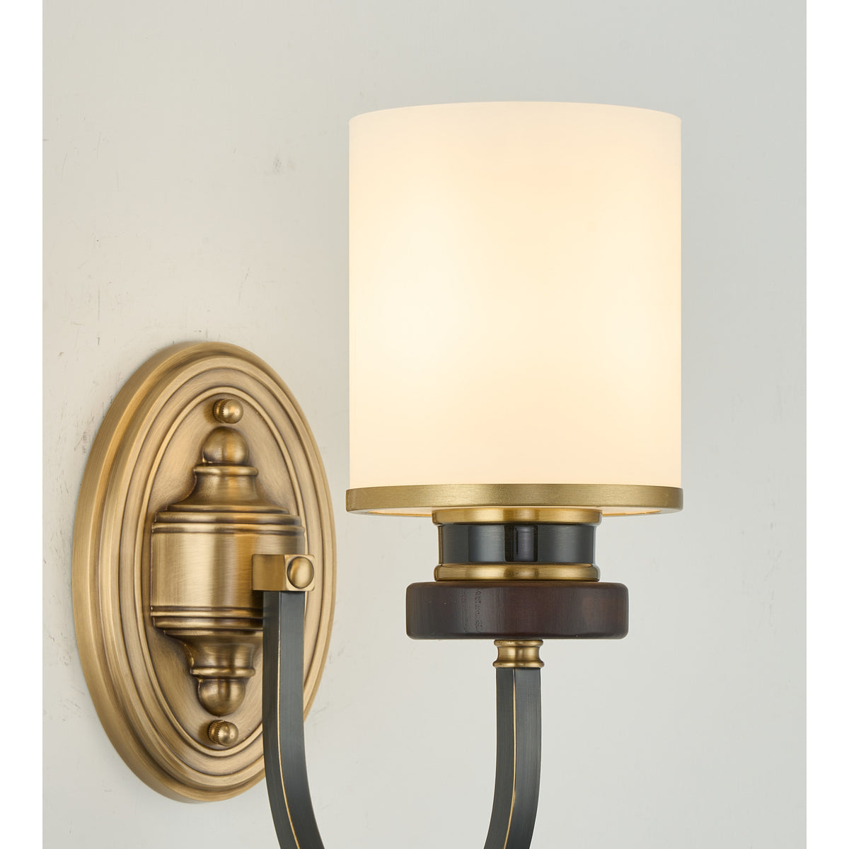 Supplier real detail photograph of the Ashbourne lit sconce fluted brass backplate and curved arm