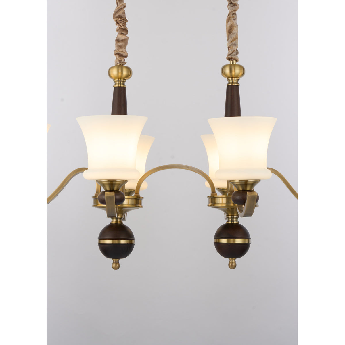 Supplier real detail crop of the Brontelle twin dark ash-wood finials and brass hubs