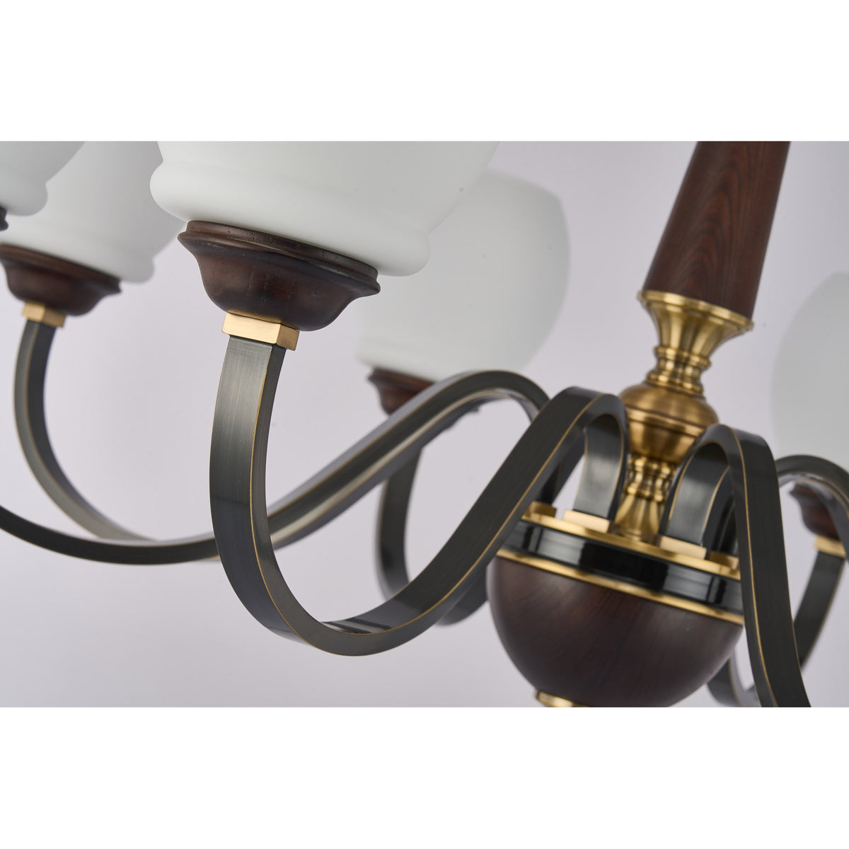 Supplier real detail photograph of the Caldwell antique-brass hub and blackened looping arms