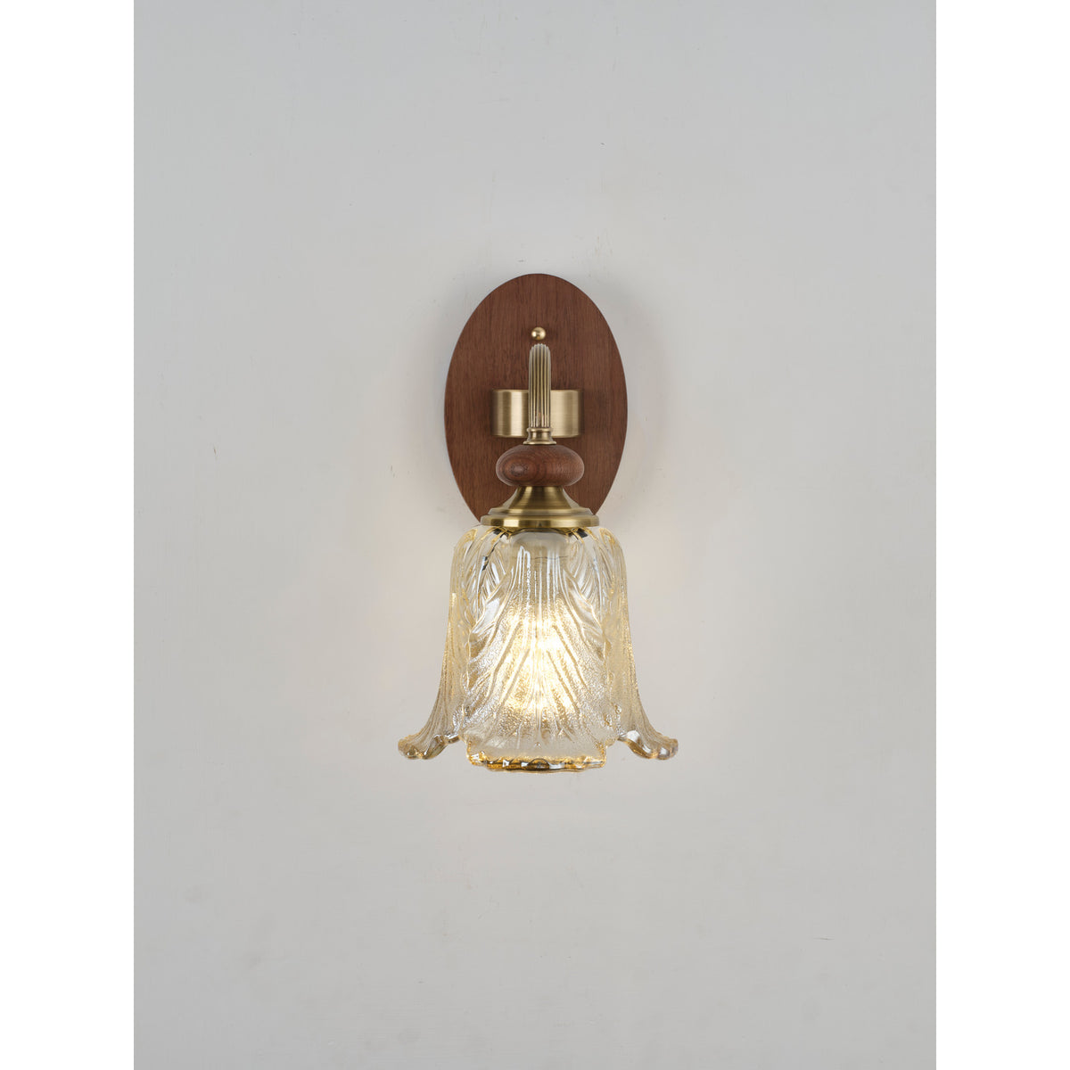 Real front product photograph of the wall sconce illuminated