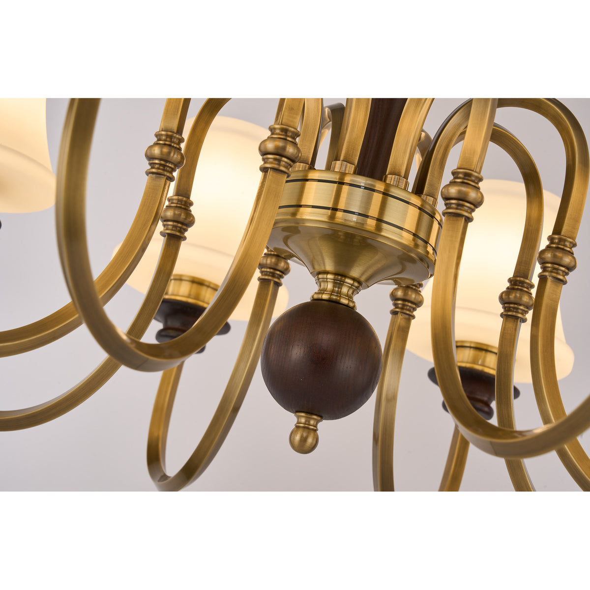 Supplier real detail photograph of Kingswell antique-brass arm junctions and lower dark-wood sphere