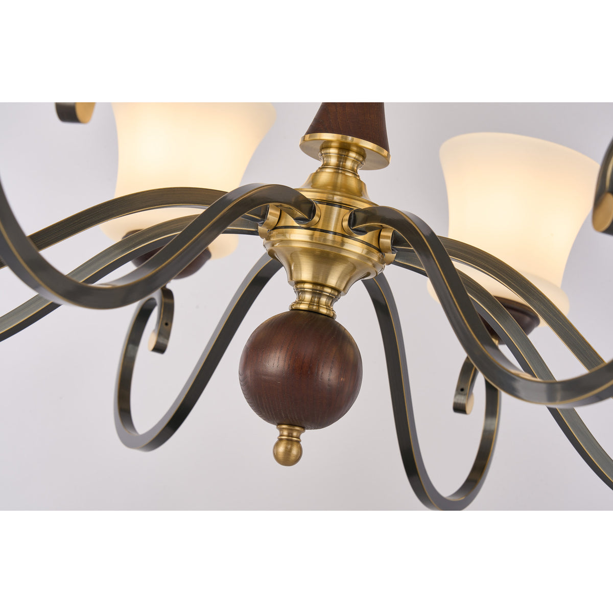 Supplier real detail photograph of the Langford antique-brass hub, dark wood ball and scrolling arms