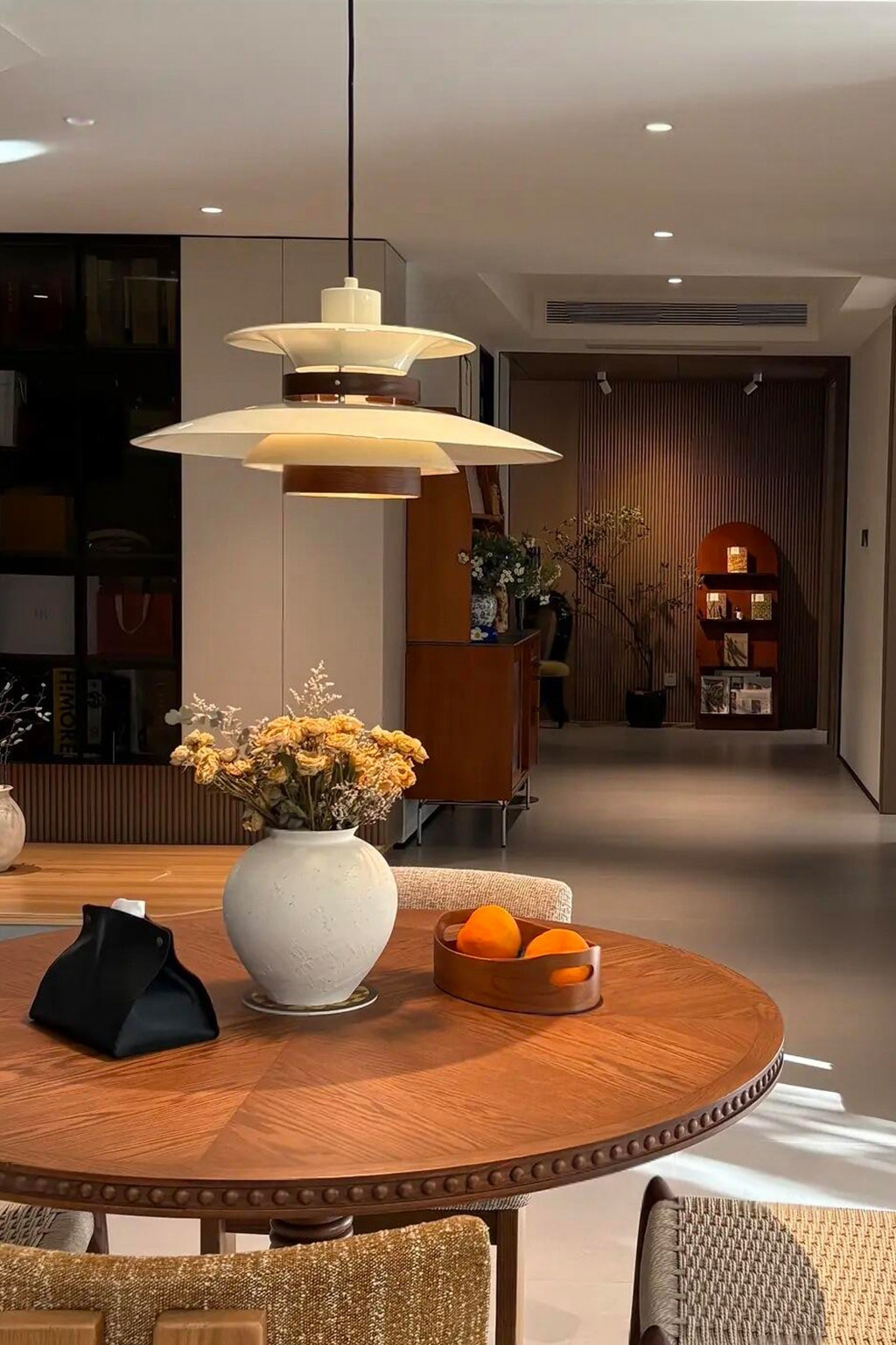 Layered Aluminum and Walnut Pendant Light — complete pendant in a wide real dining-room view