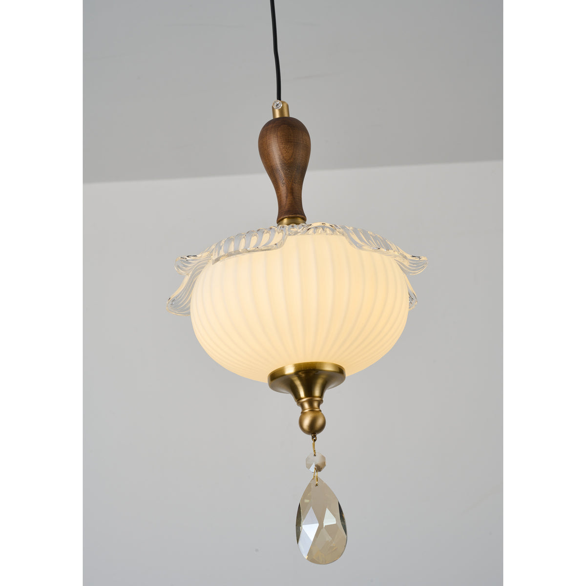 Supplier real detail photograph of Valloren Pendant B walnut neck, ribbed globe and crystal detail lit