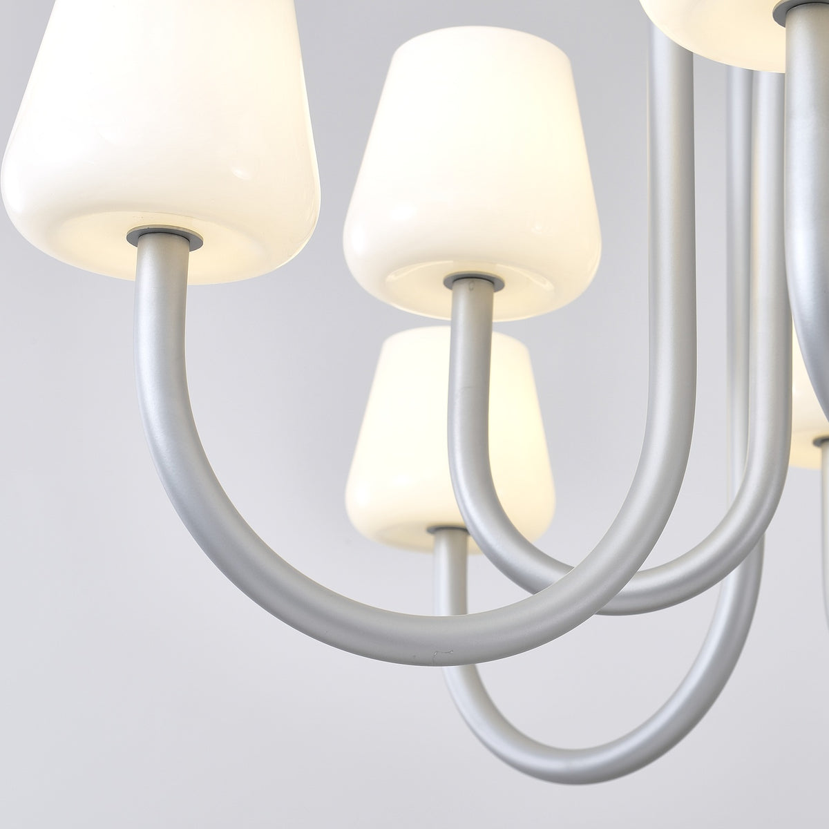 Close supplier photograph of Apollo opal glass shades and gray aluminum curved arms