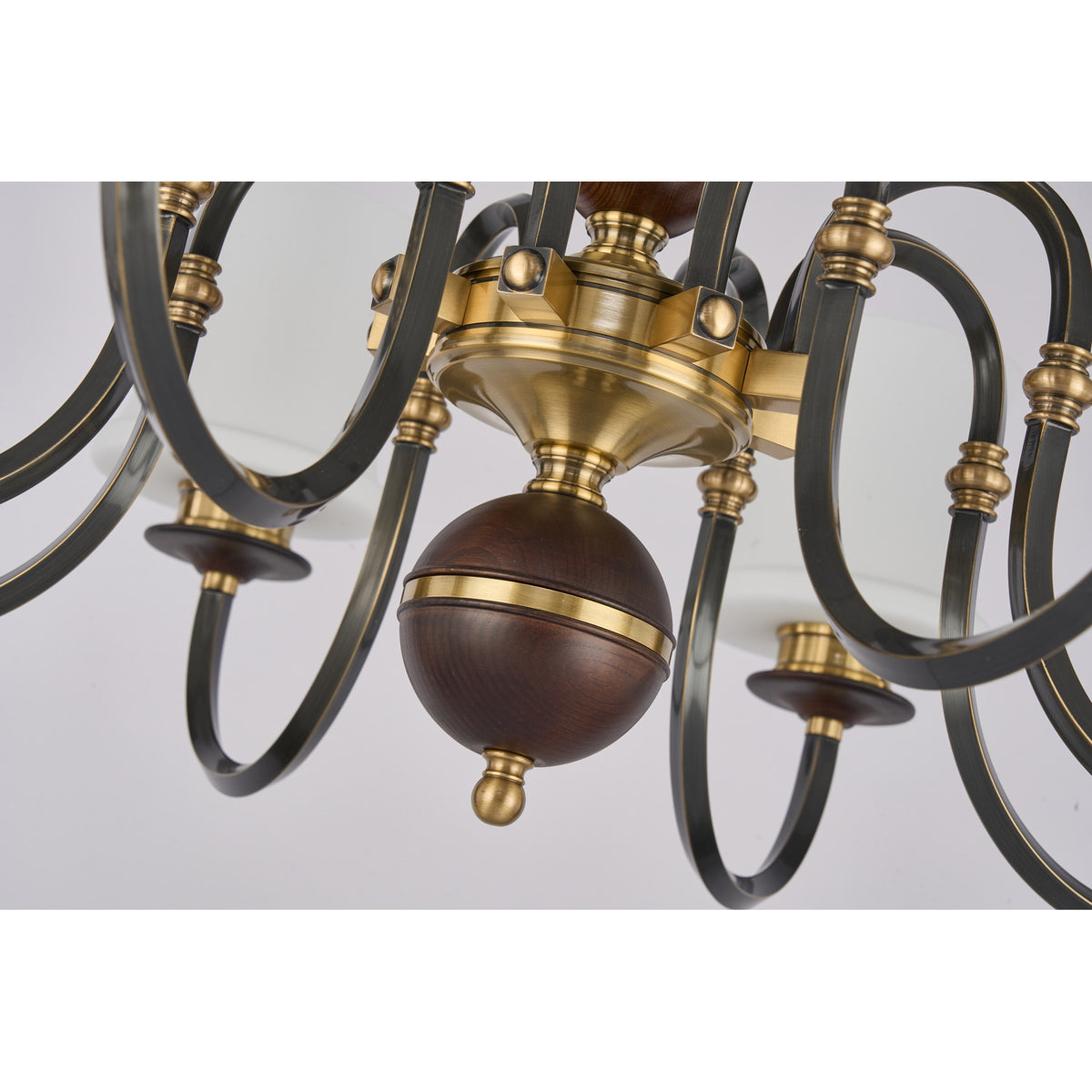 Supplier real detail photograph of the Ebonelle antique brass hub, blackened arms and deep ash-wood finial