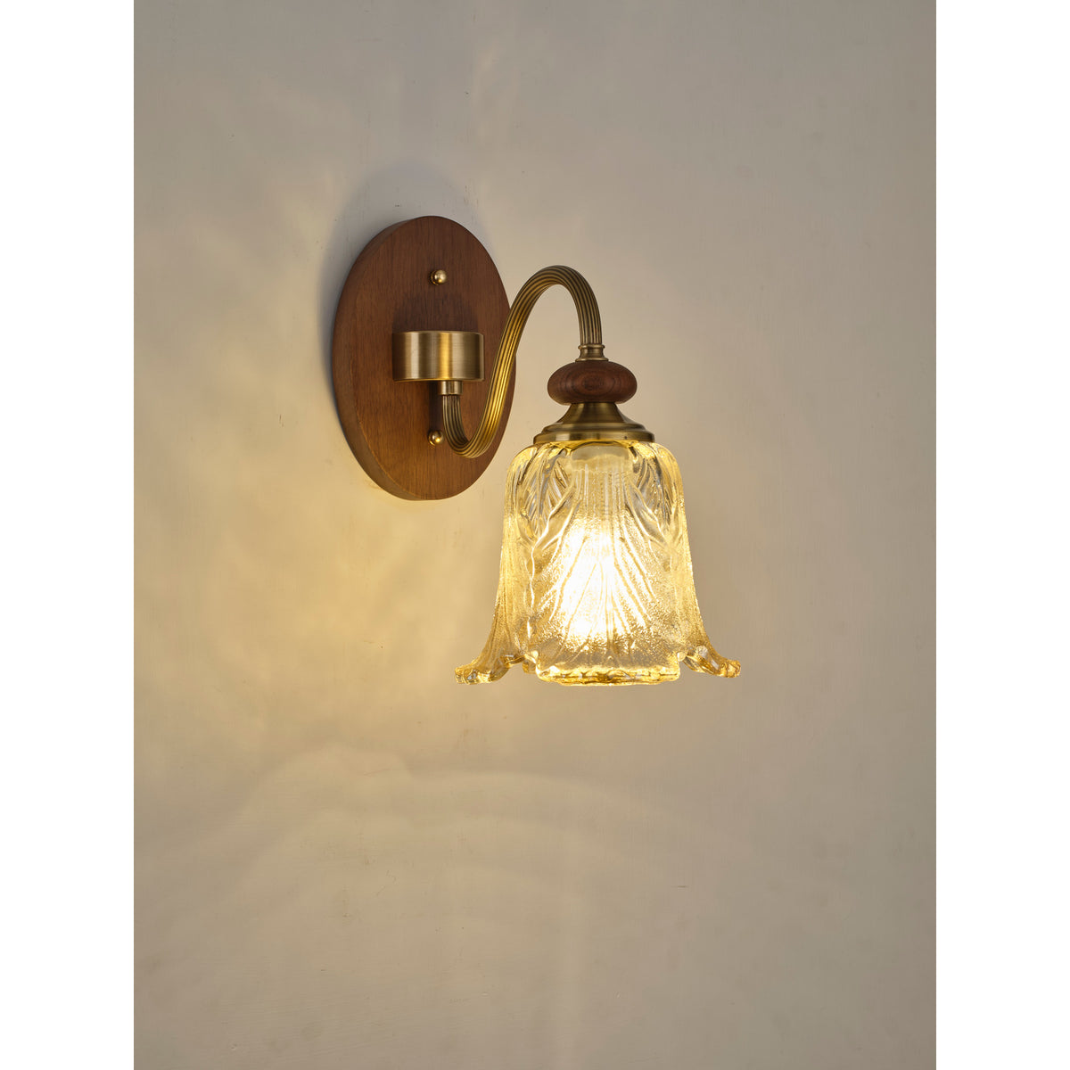 Real three-quarter product photograph of the wall sconce illuminated