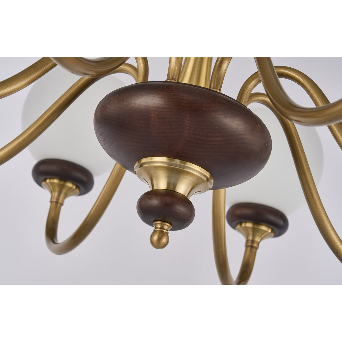 Supplier real detail photograph of the Ravenelle dark ash-wood lower hub and brass finial
