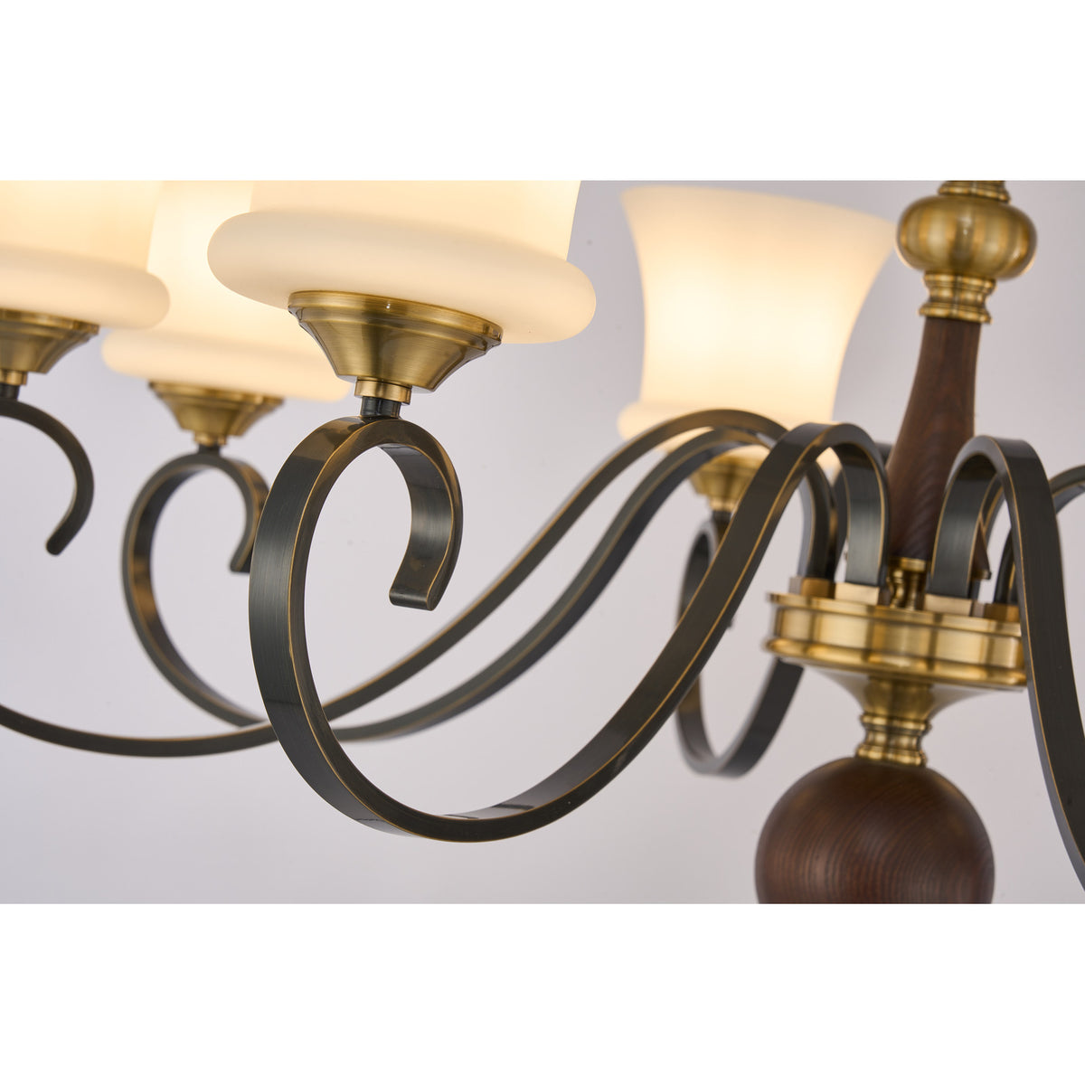 Supplier real detail photograph of the Rosethorne blackened scroll arms and antique-brass center ring