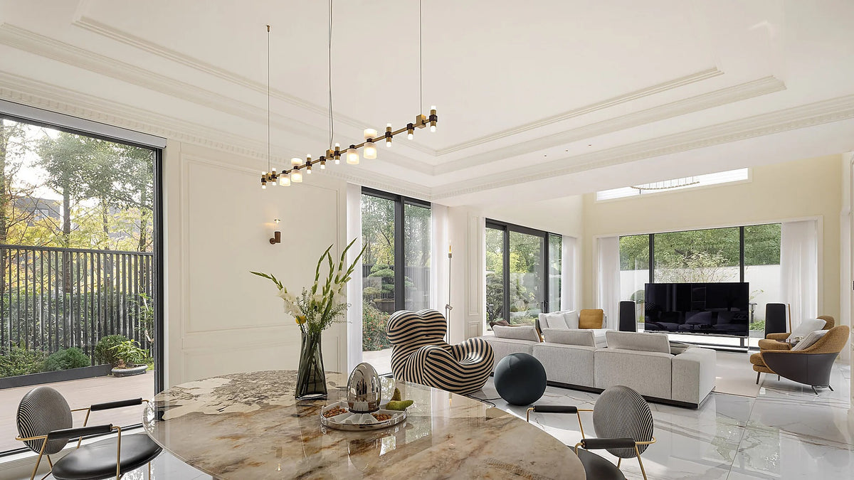 Royal linear pendant suspended over an open-plan dining area