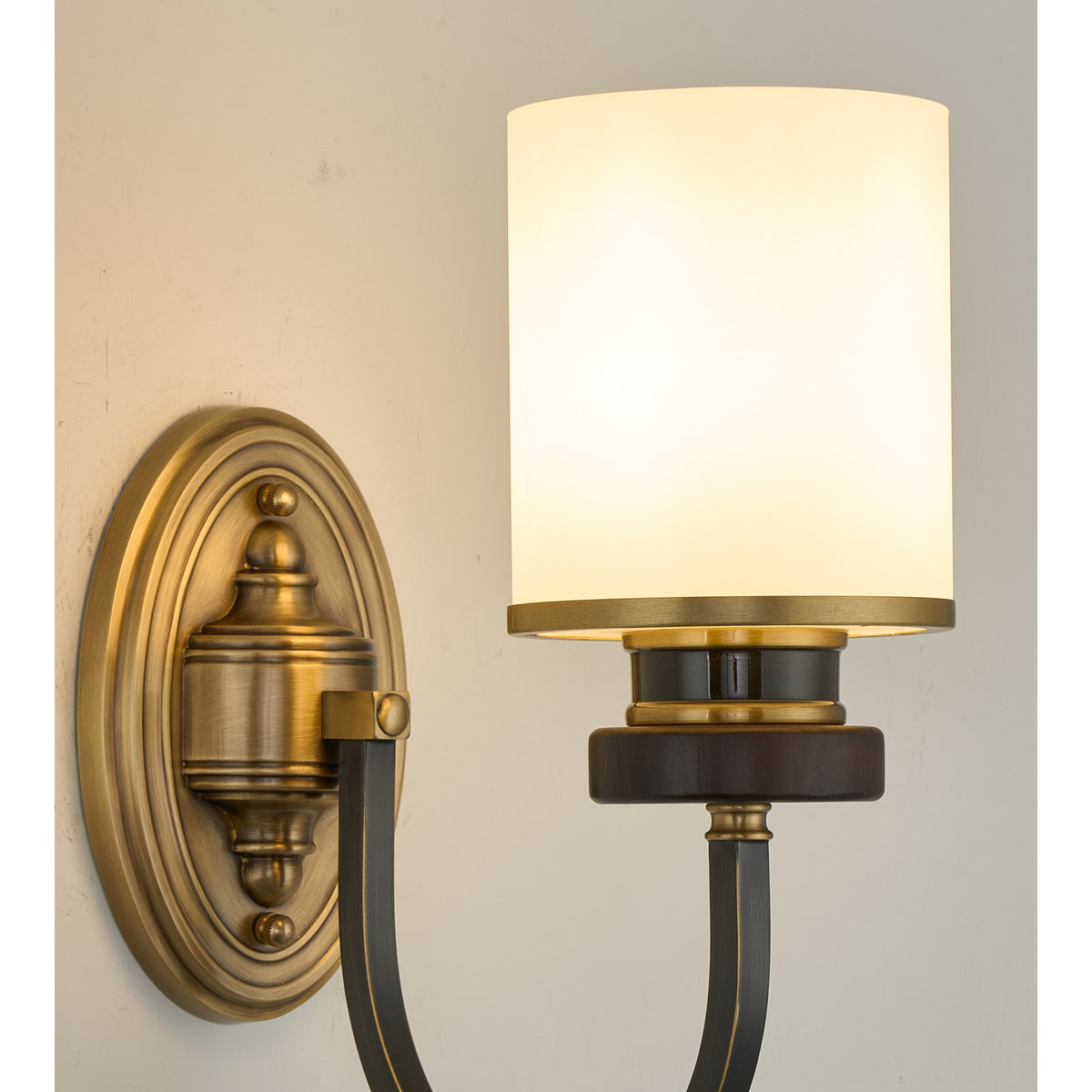 Supplier real detail photograph of the Ashbourne opal shade, ash-wood collar and aged-brass wall plate