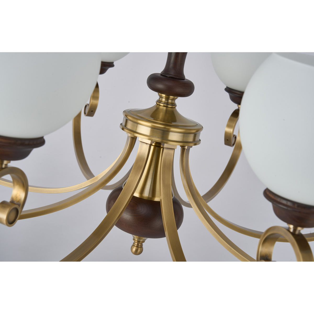 Supplier real detail photograph of the Aurellane antique brass center hub and sculptural wood spindle