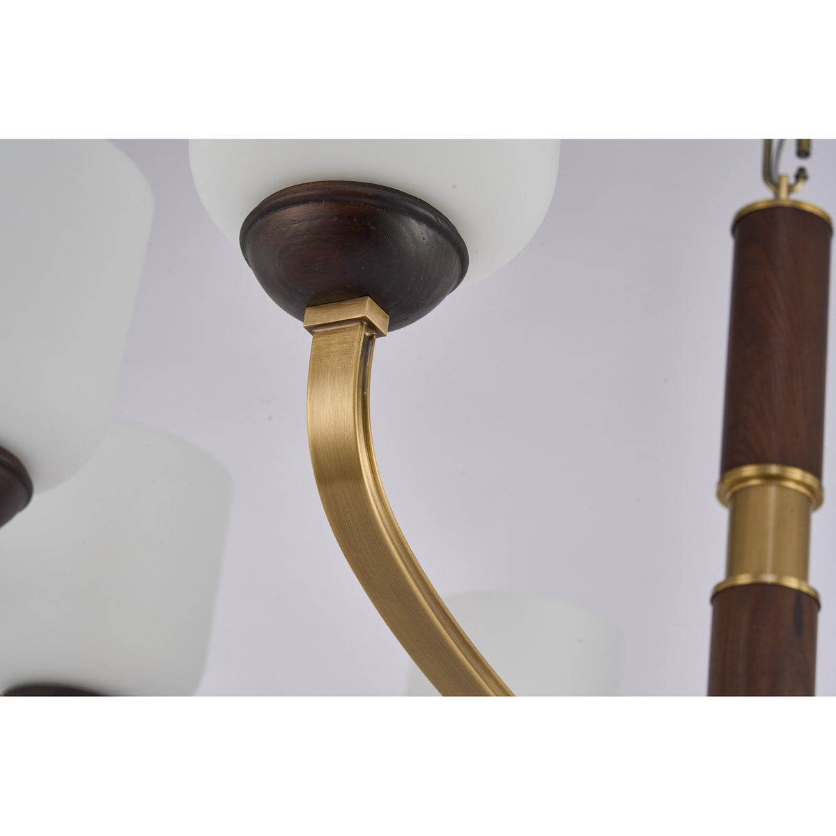 Supplier real detail photograph of the Bellgrave opal glass shade, dark wood collar and curved brass arm
