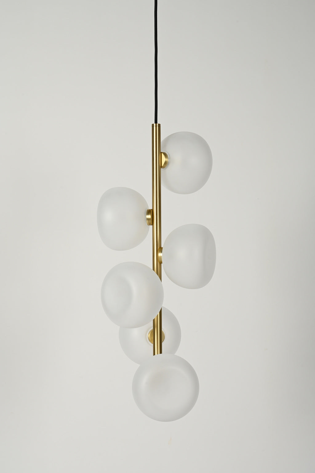 Frosted glass six-light vertical pendant in Natural Brass, unlit product view