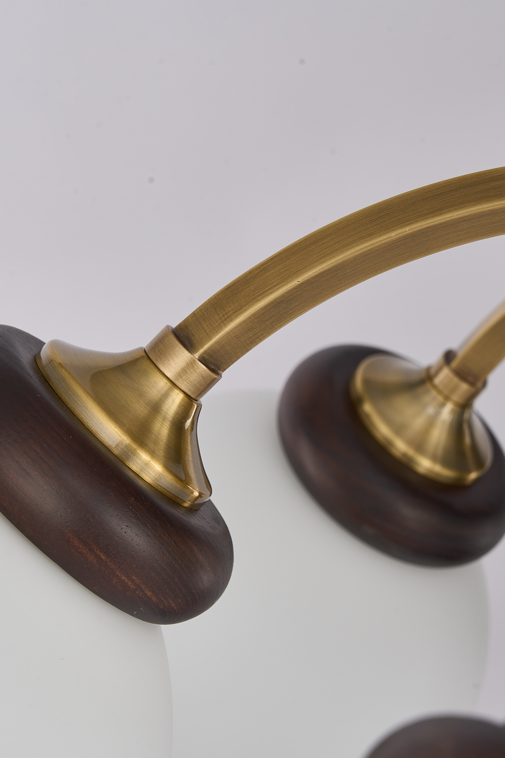 Arborenne milk-glass shade, dark ash-wood collar and paired curved arm detail