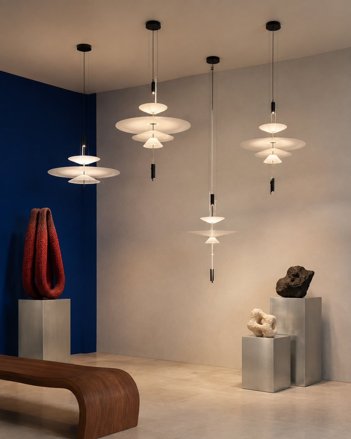 Layered acrylic disc pendants arranged as a sculptural constellation in an art space