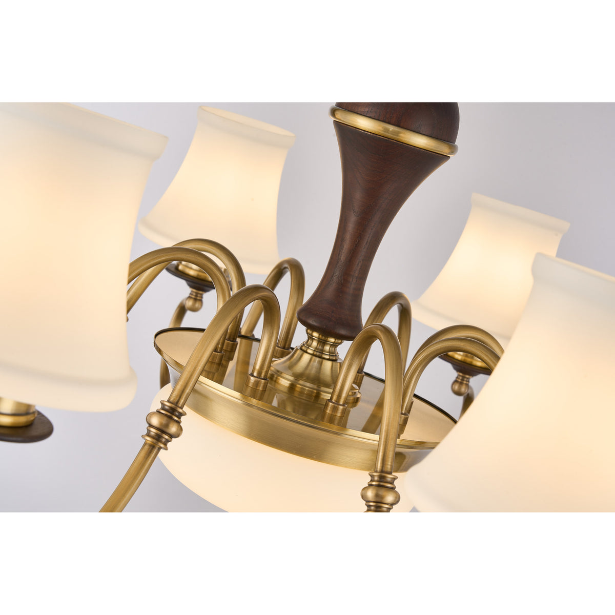 Supplier real detail photograph of the Glenhaven antique-brass arm junctions and dark ash-wood center