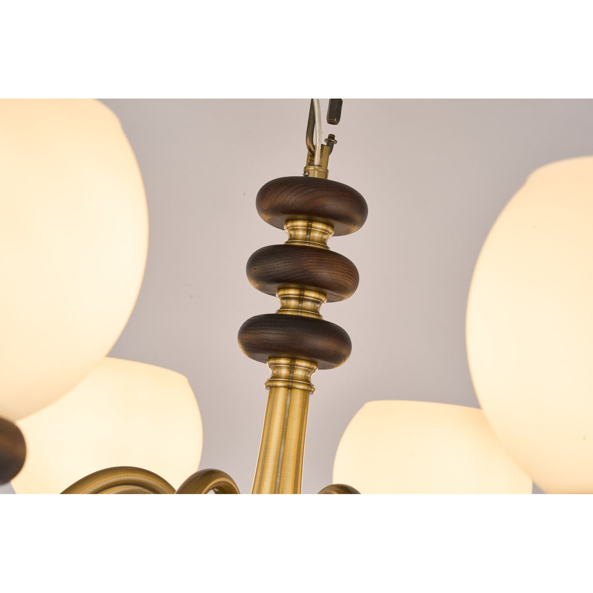 Supplier real detail photograph of the Ravenelle three stacked ash-wood discs on the brass center column