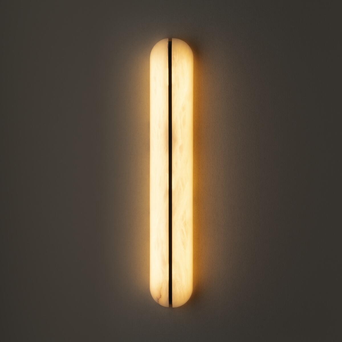 Real large alabaster capsule wall sconce illuminated view
