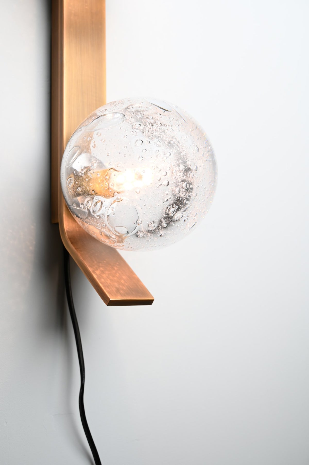Modern Glass Globe Wall Sconce in Antique Brass - 11 11-real-shot-glass-globe-wall-sconce-close-up