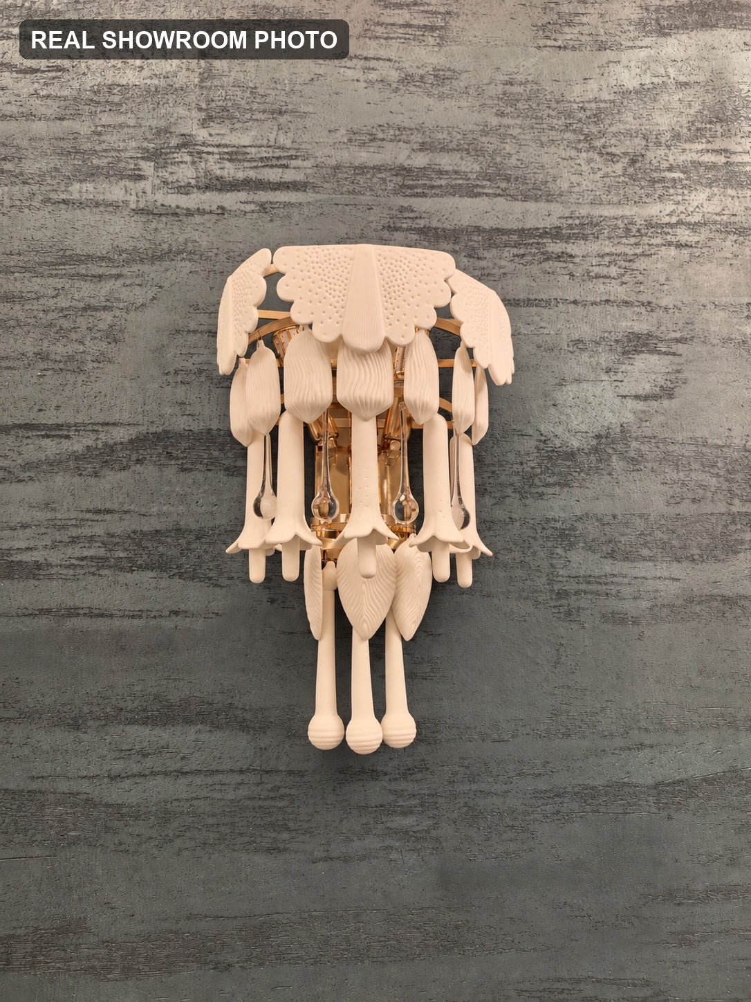 Real showroom photo — Muguetelle ivory ceramic wall sconce unlit view