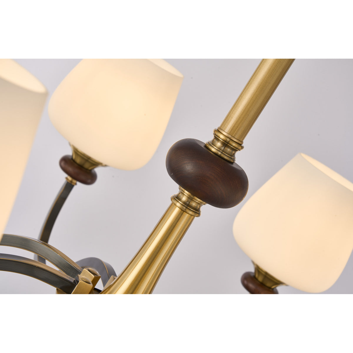 Supplier real detail photograph of the Wetherby antique-brass center stem and dark ash-wood collar