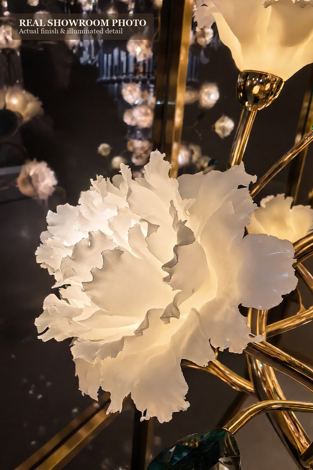 Sylverelle wall sconce – close showroom view of illuminated white floral shade and gold-tone connection