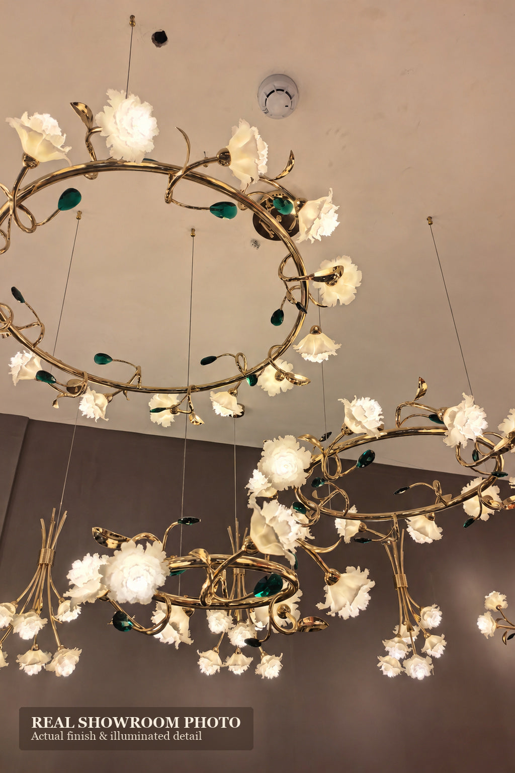 Sylverelle chandelier – phone-shot showroom view of large and small floral ring chandeliers