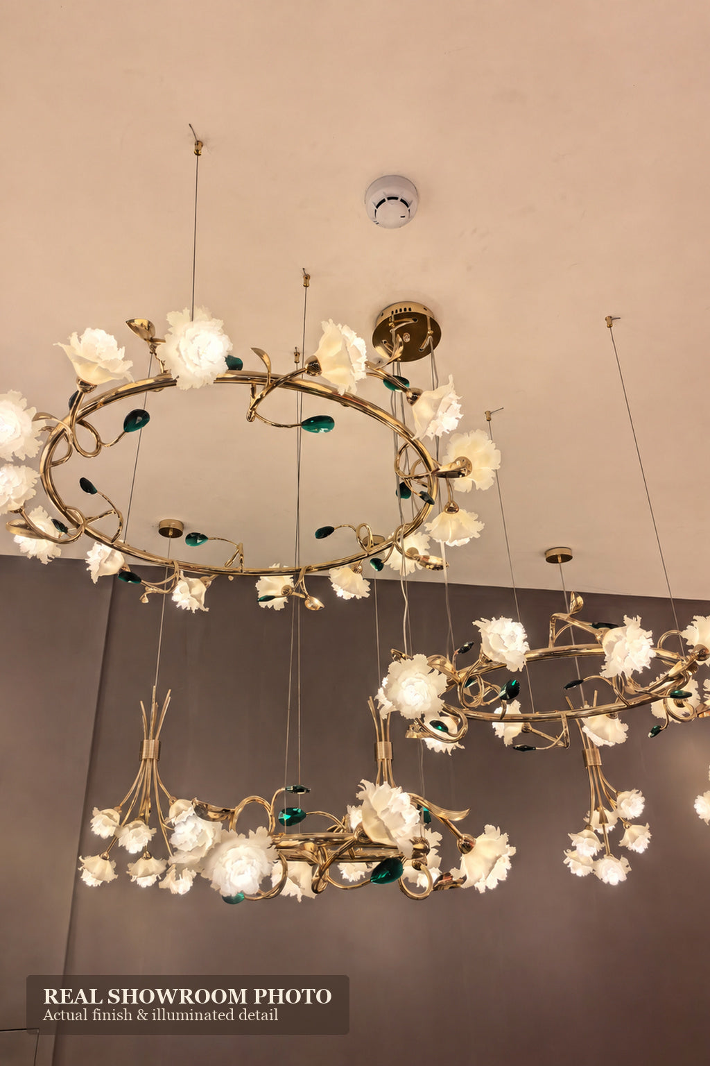 Sylverelle chandelier – second phone-shot showroom view of suspended floral ring chandeliers