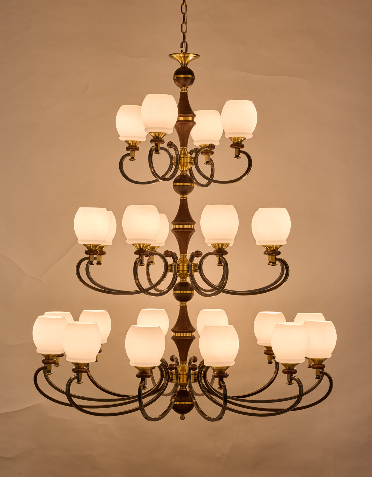 Real front photograph of the Briarwood 12 plus 8 plus 4 light three-tier chandelier illuminated