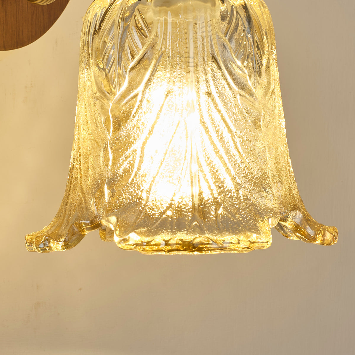 Real wall sconce detail showing the sculpted leaf glass shade
