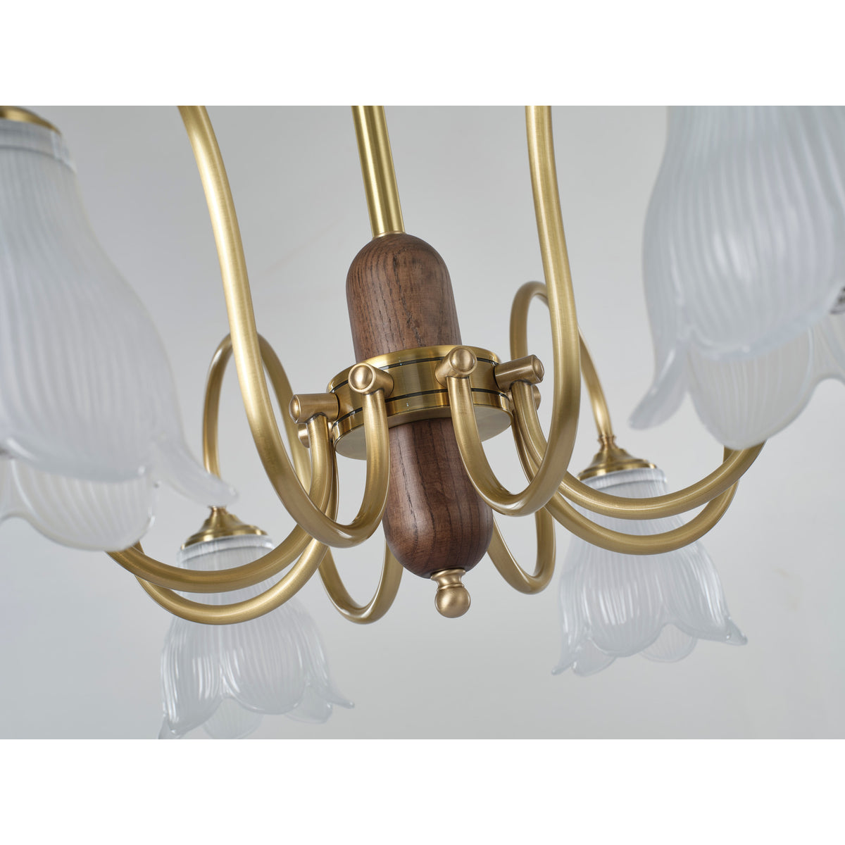 Supplier real chandelier detail showing the walnut-finished hub and looping arms