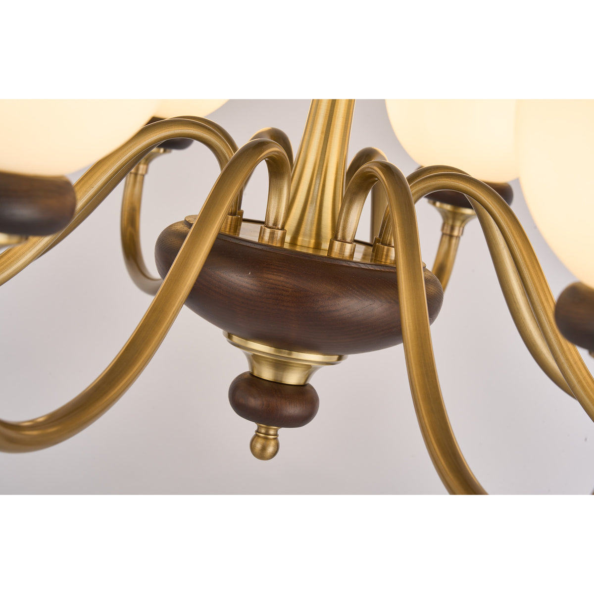 Supplier real detail photograph of the Ravenelle antique brass arm junction and broad ash-wood center hub