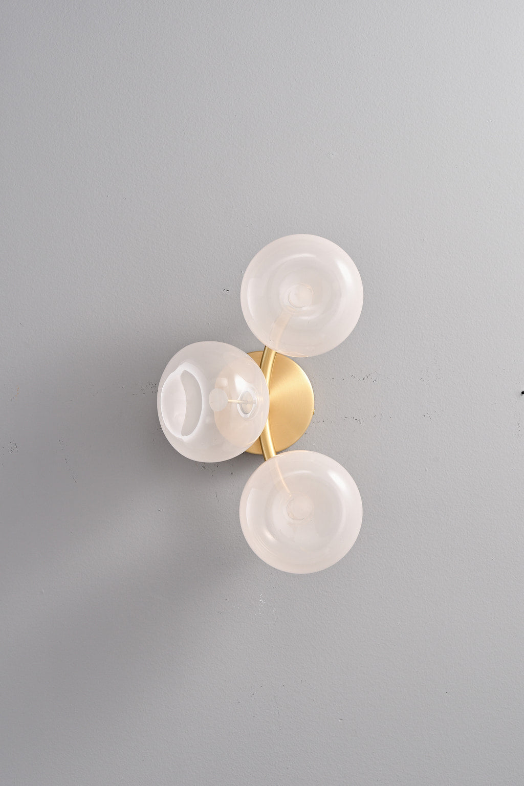 Modern Glass Globe Branch Wall Sconce in Natural Brass - 3 shades pink glass, lights off front view