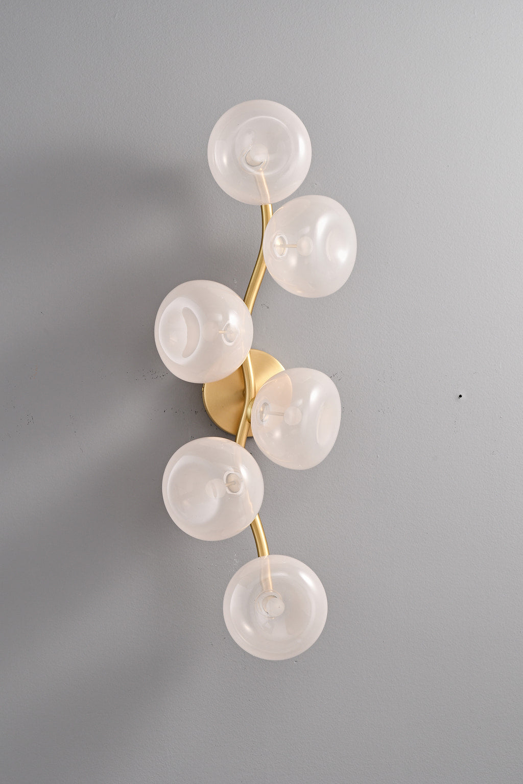 Modern Glass Globe Branch Wall Sconce in Natural Brass - 6 shades pink glass, lights off front view