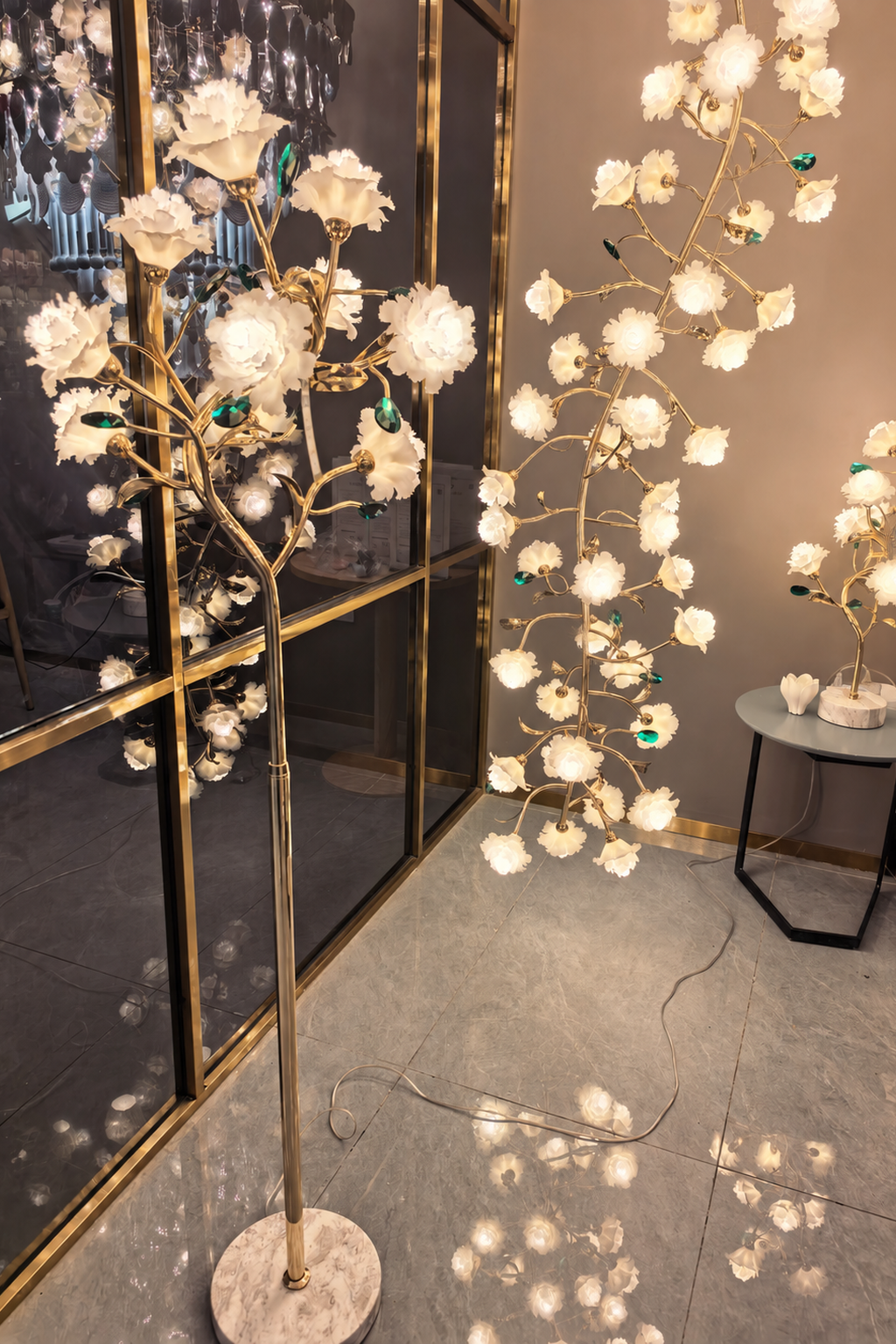 Sylverelle floor lamp – phone-shot showroom view with matching floral lighting in the background
