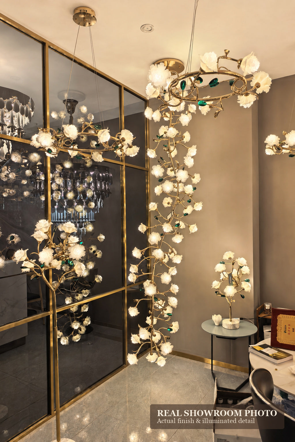 Sylverelle chandelier – phone-shot showroom view of long floral branch chandelier among matching series fixtures