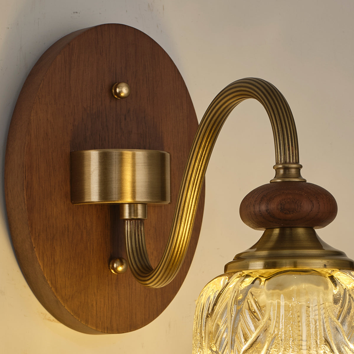 Real wall sconce detail showing the oval ash-wood backplate