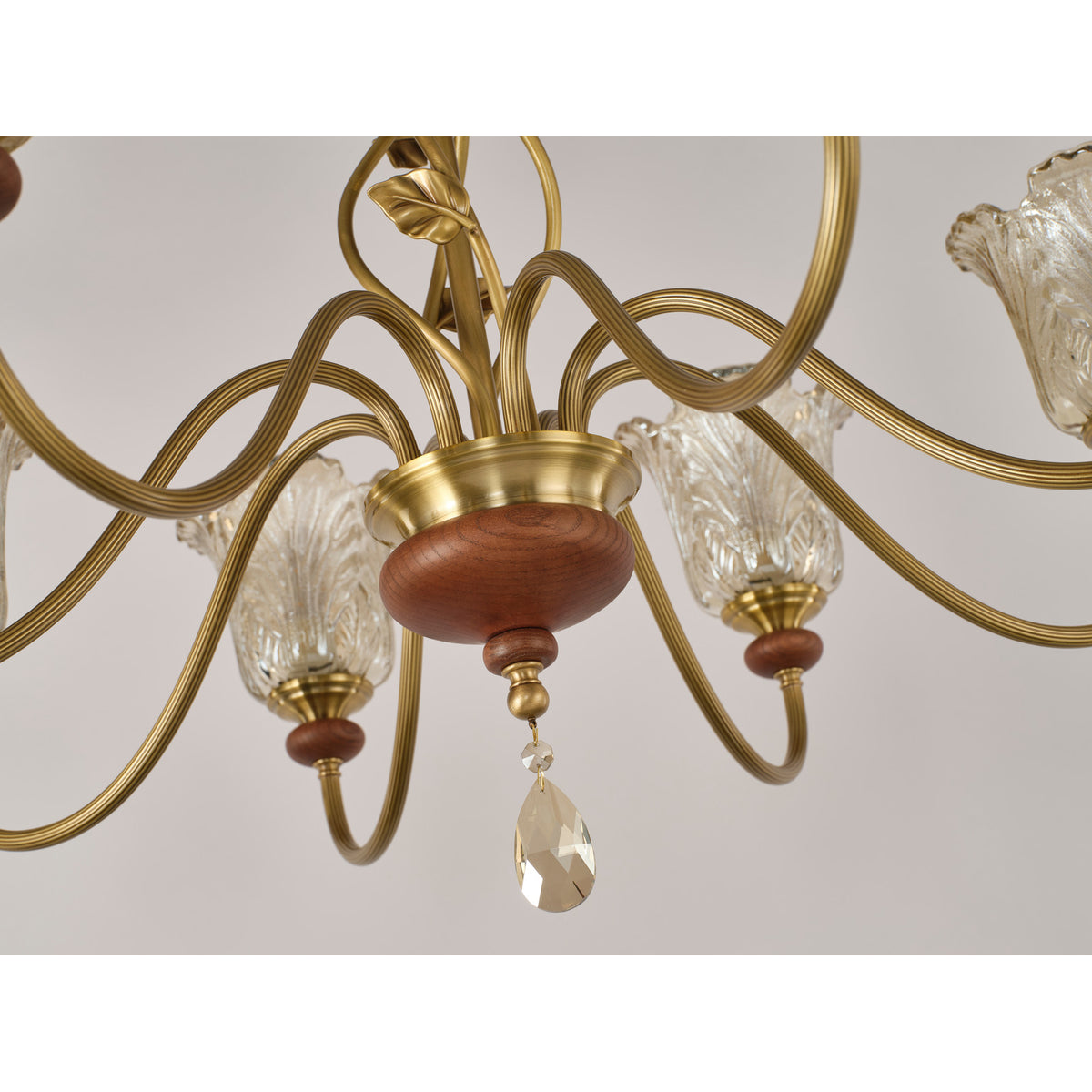Real chandelier detail showing the ash-wood hub and faceted crystal drop