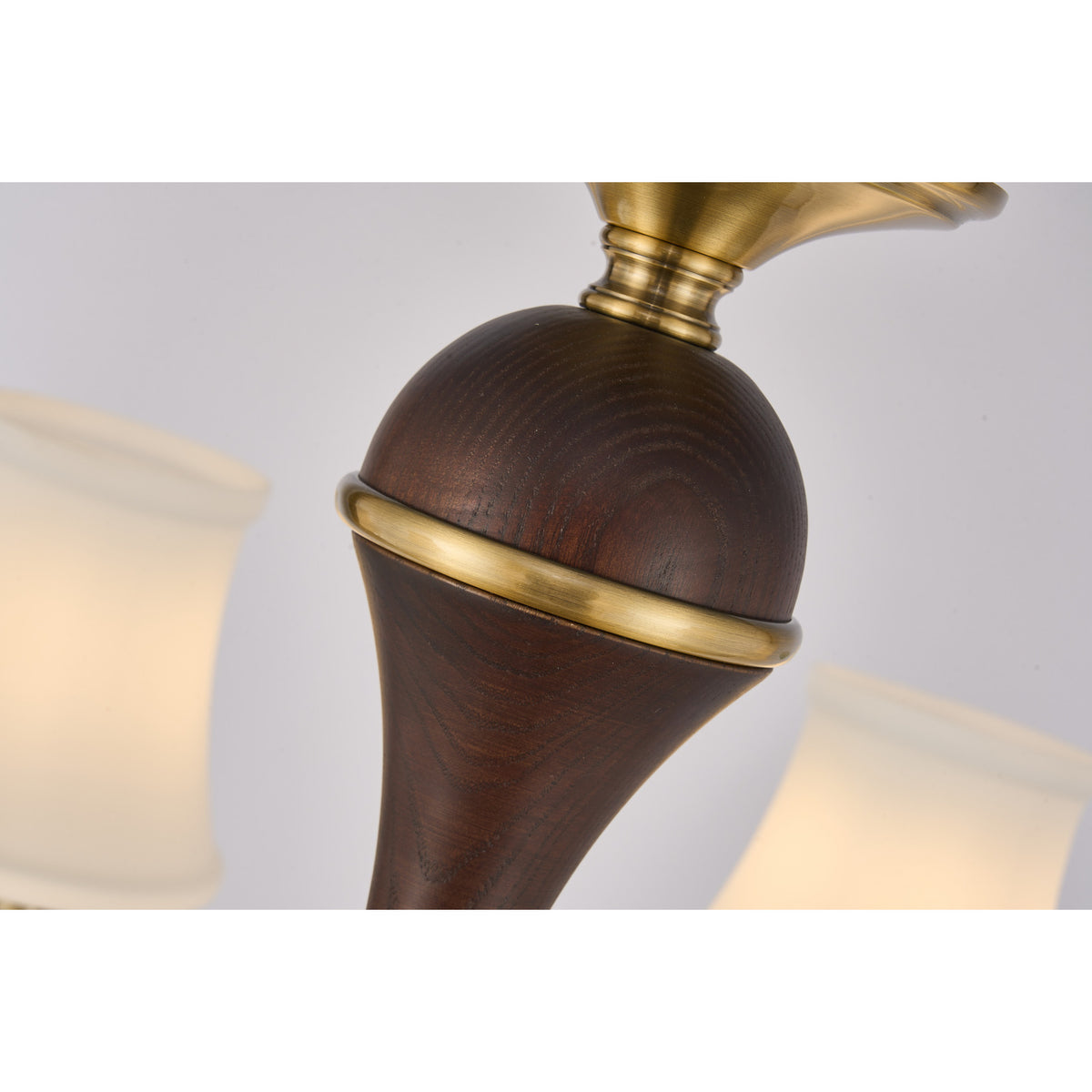 Supplier real detail photograph of the Glenhaven dark ash-wood spindle and antique-brass collar