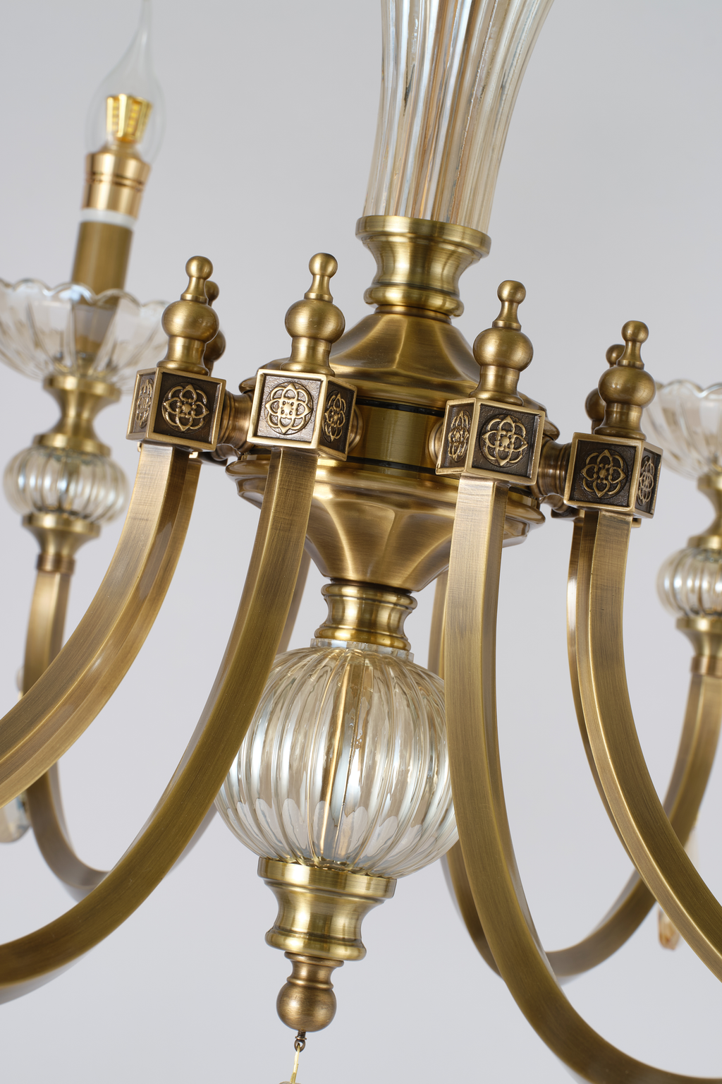 Lucerayne decorated center hub and curved antique-bronze copper arms detail