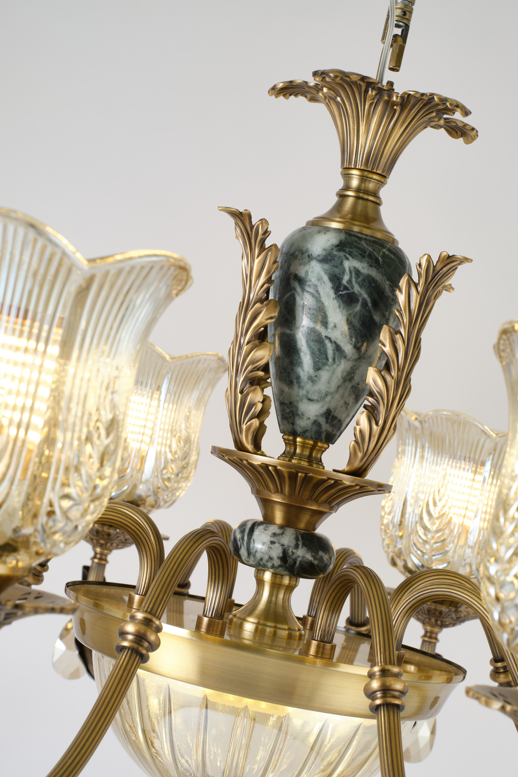 Marmavelle dark marble-effect center column and sculpted antique-bronze leaf detail