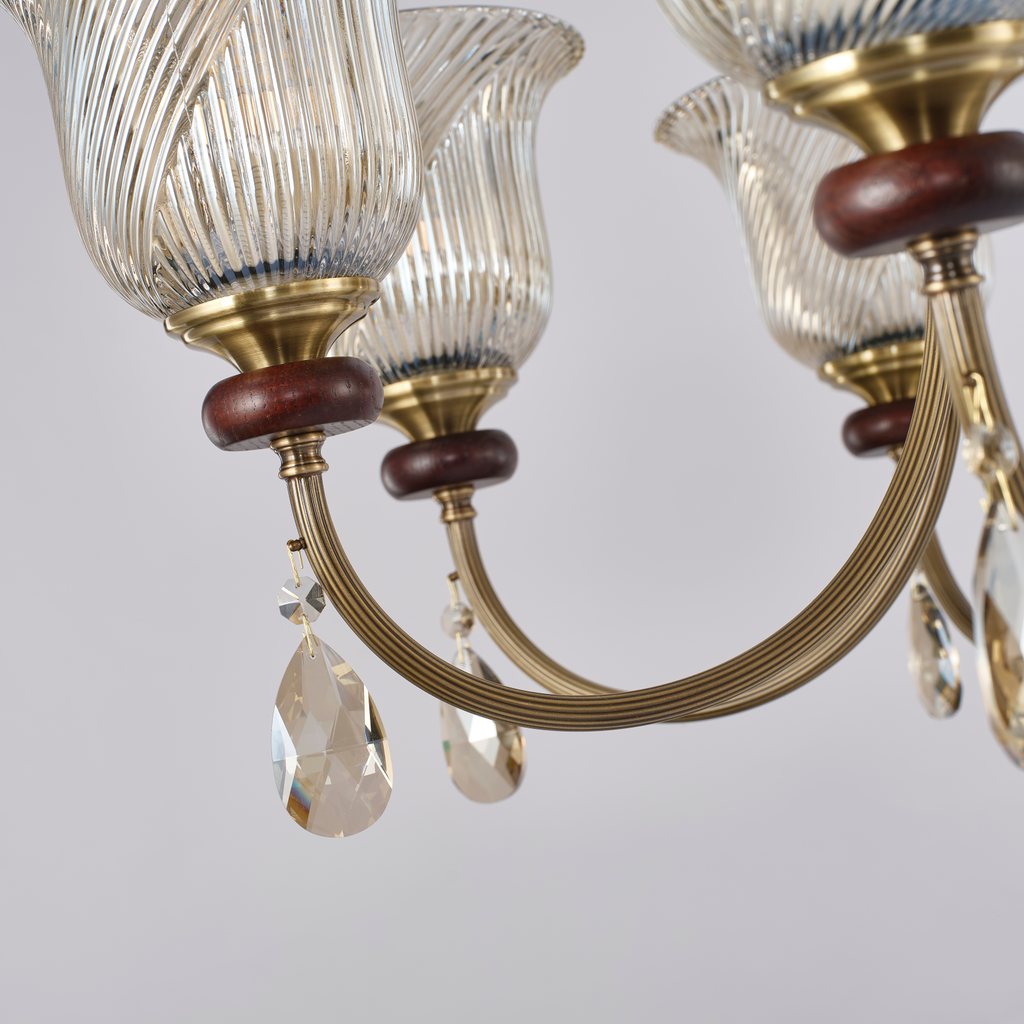 Rillavine curved antique-bronze arm, ash-wood accent and faceted clear glass drop detail