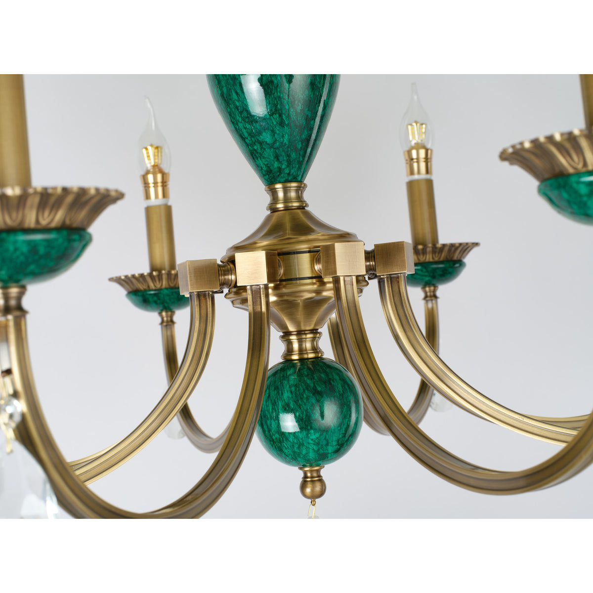 Real Valeria chandelier detail showing the brass arm junction
