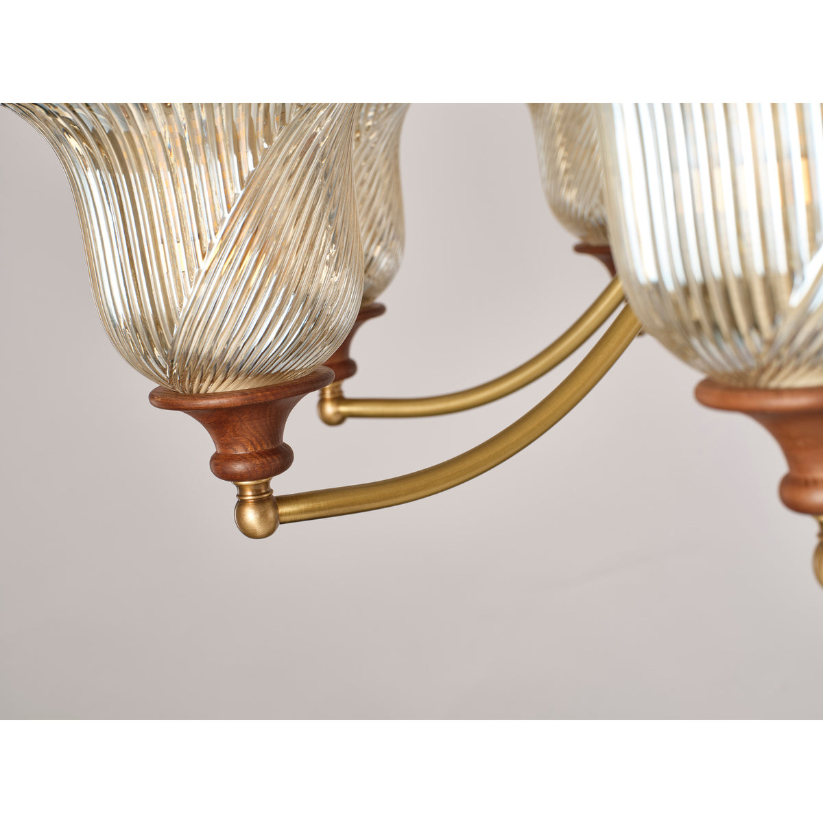 Real Elowen chandelier detail showing the brass arm and wooden shade cup