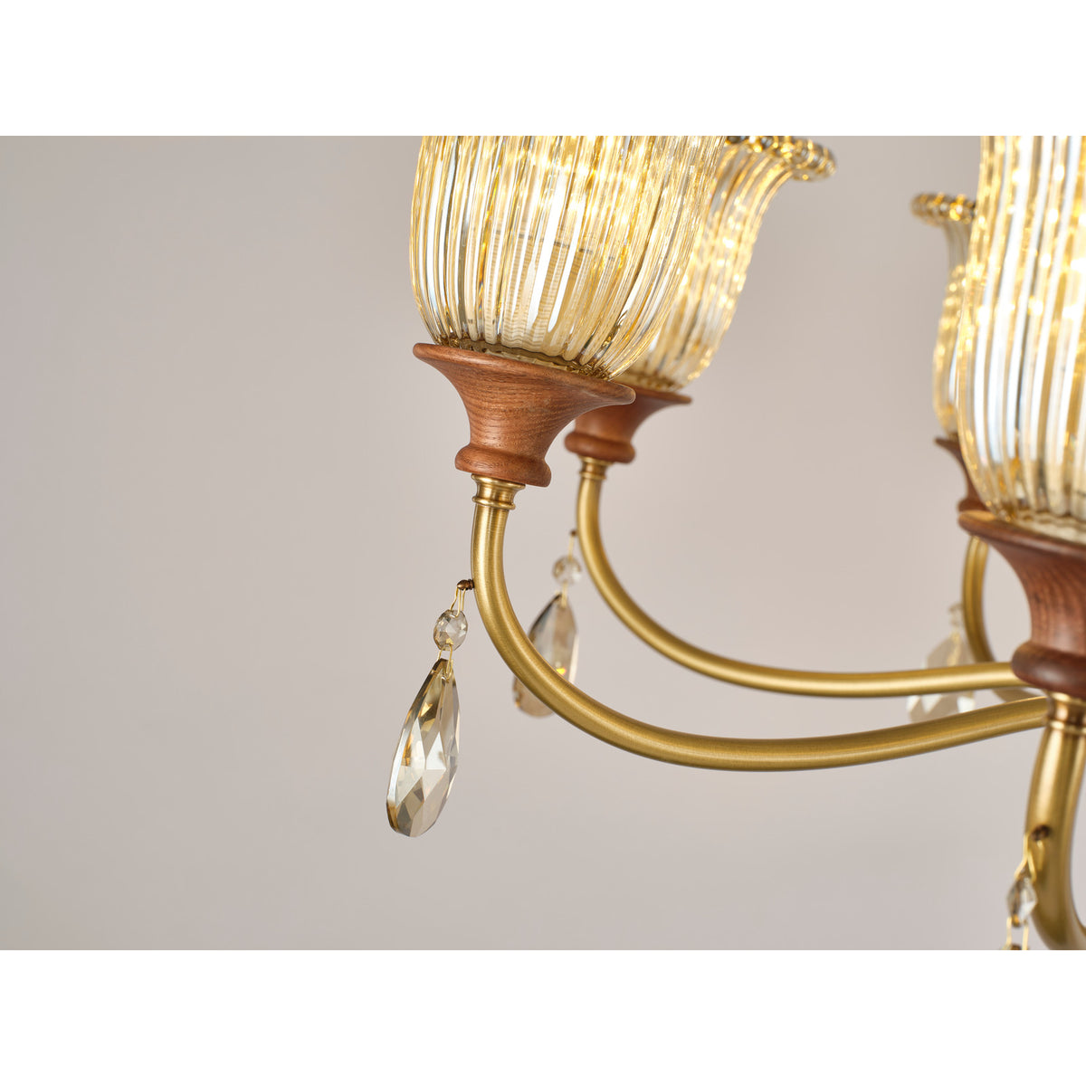 Real Rosalind chandelier detail showing the looping brass arm