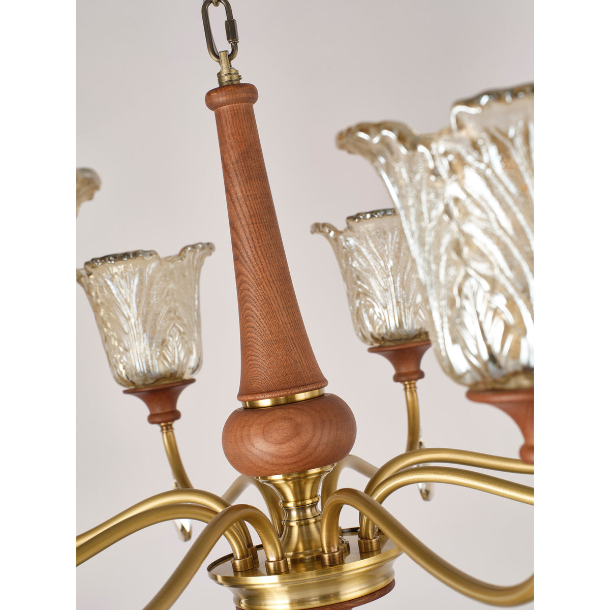 Real Aurelia chandelier detail showing the warm ash-wood spindle