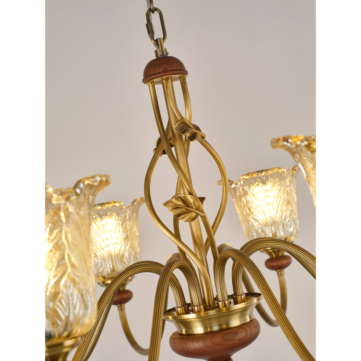 Real chandelier detail showing the upper stem and ash-wood cap