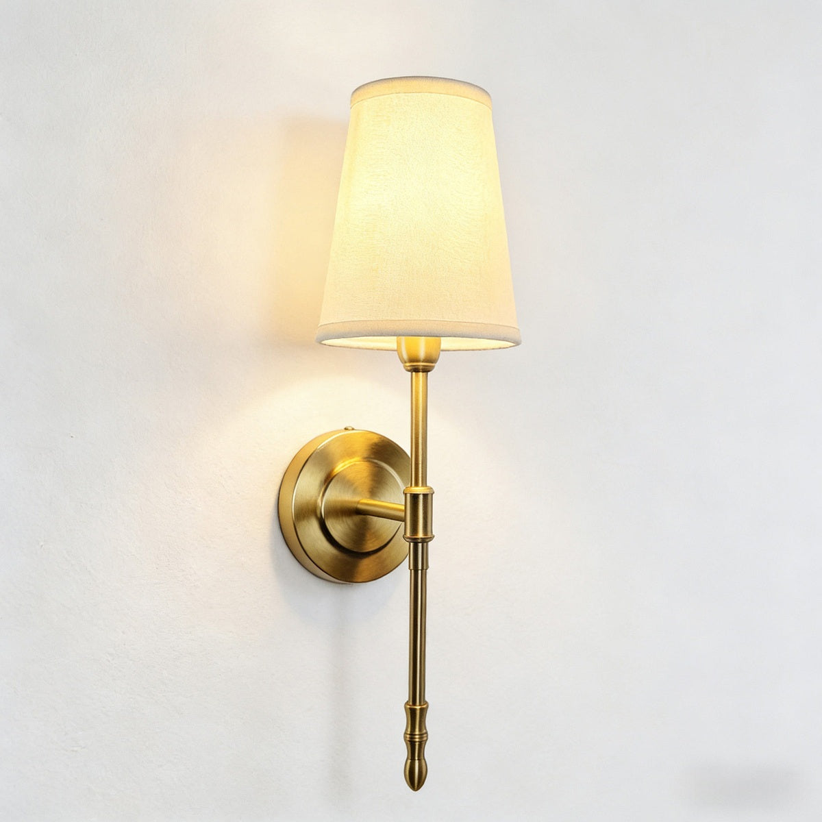 Antique Brass Fabric Shade Wall Sconce real front lit view